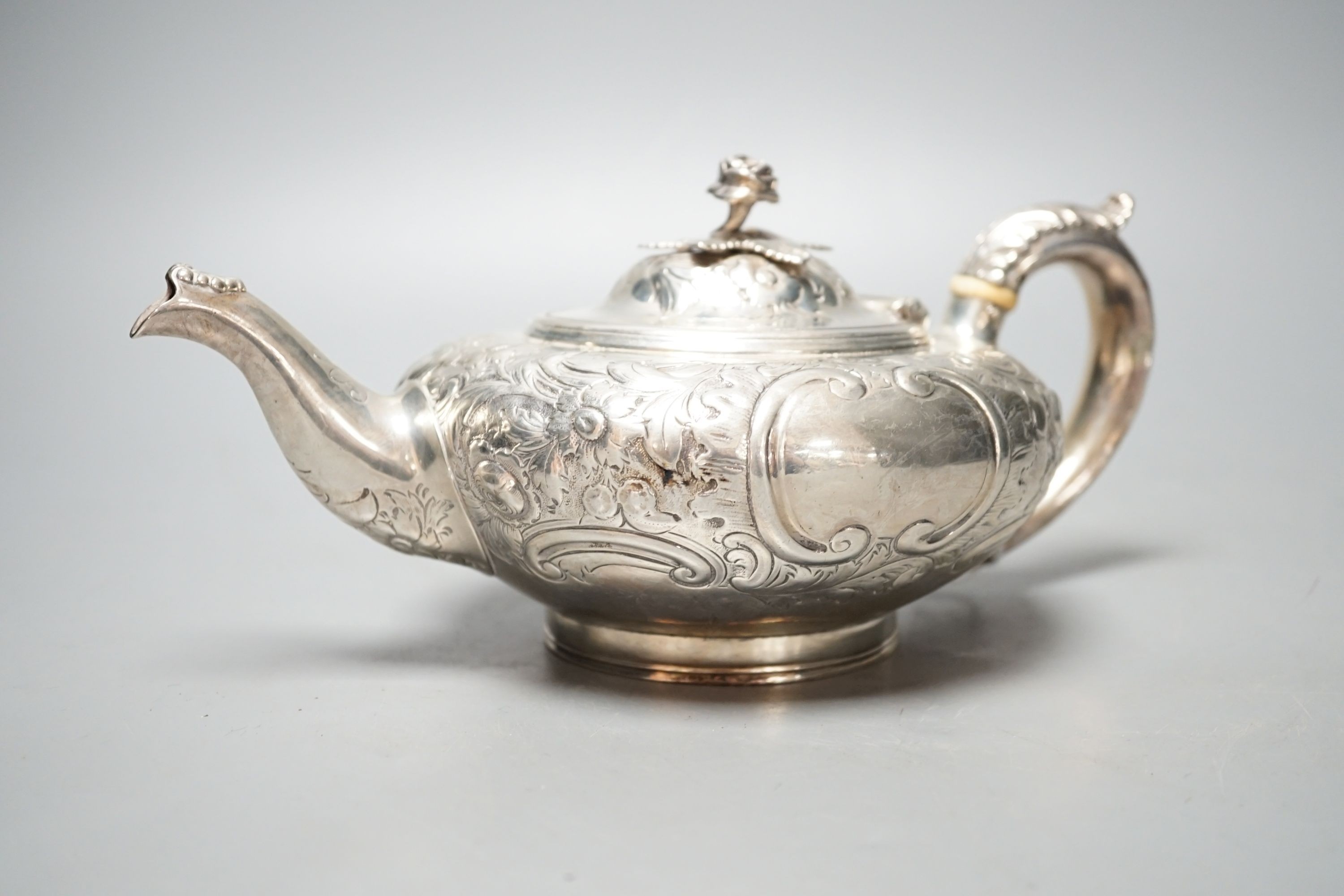 A Victorian embossed silver teapot, Walter Morrise, London, 1842, gross 15.5oz.